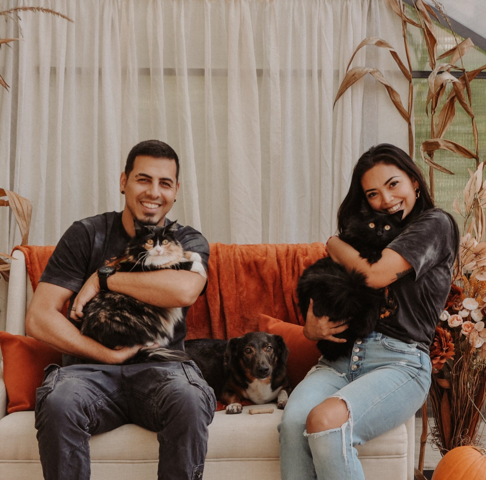 Christiano and Pammela with their rescued dog Kiko and cats Midnight and Peach